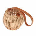 Round woven rattan planter basket with a brown leather look strap