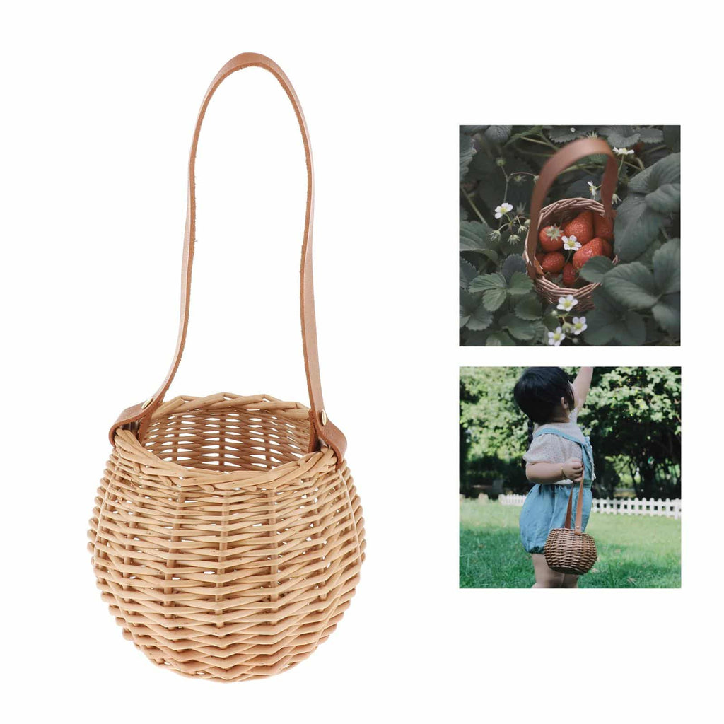 Round woven rattan planter basket with a brown leather look strap