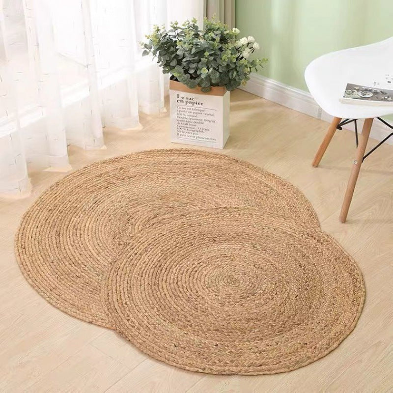 Two round honey braided rugs on a light floor