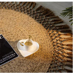 Round jute rug with a tassel fringe in a bright room