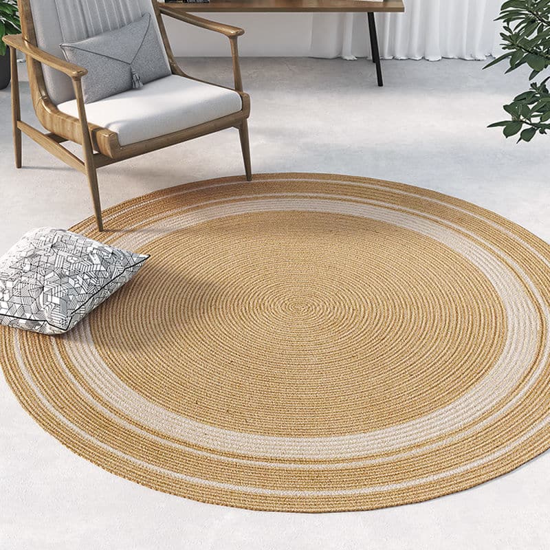 Round jute rug with two white rings under an armchair