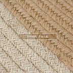 Round jute rug with two white rings under an armchair