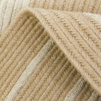 Round jute rug with two white rings under an armchair