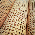 Roll of natural rattan cane webbing with a round open mesh