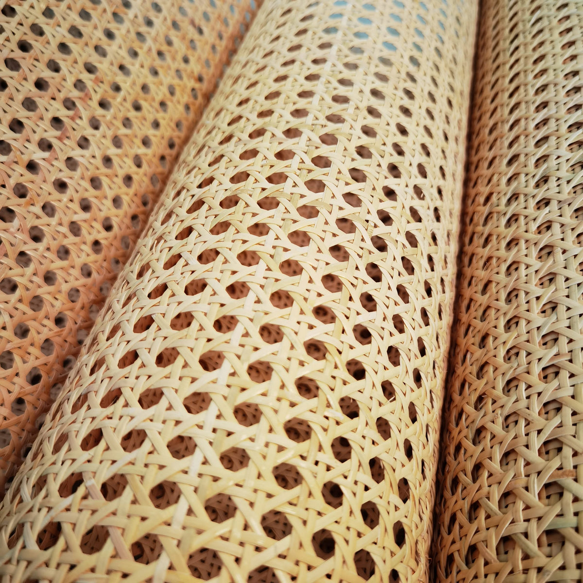 Roll of natural rattan cane webbing with a round open mesh