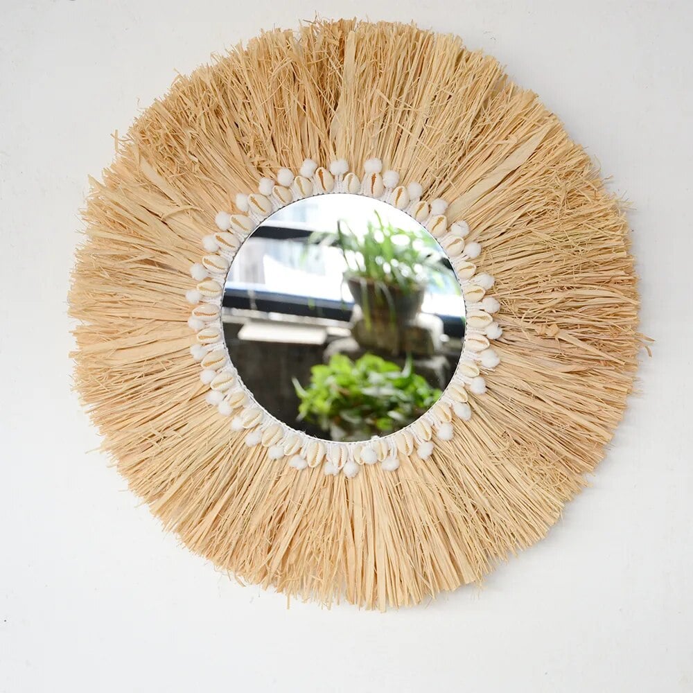 Round mirror framed by a natural fiber fringe