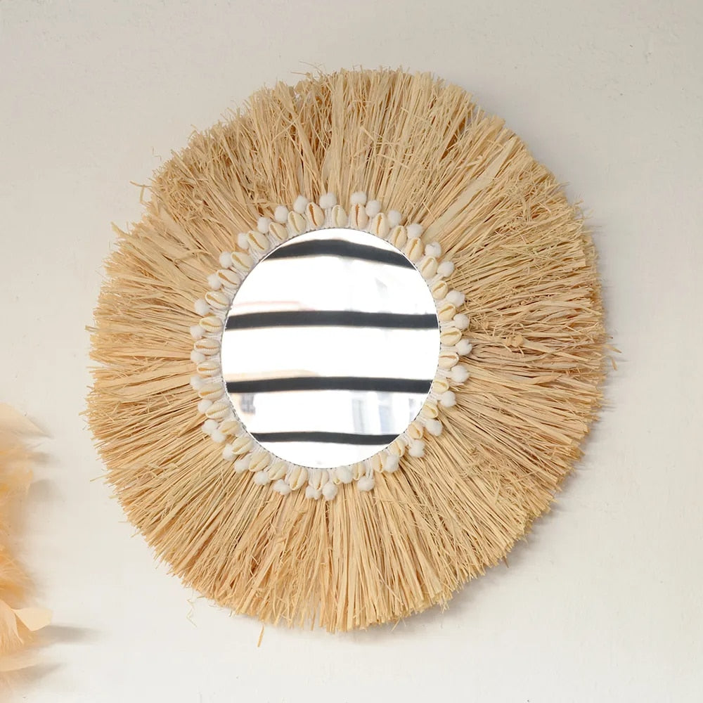 Round mirror framed by a natural fiber fringe