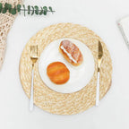 Round sand toned woven linen placemat with a straw look and non slip back