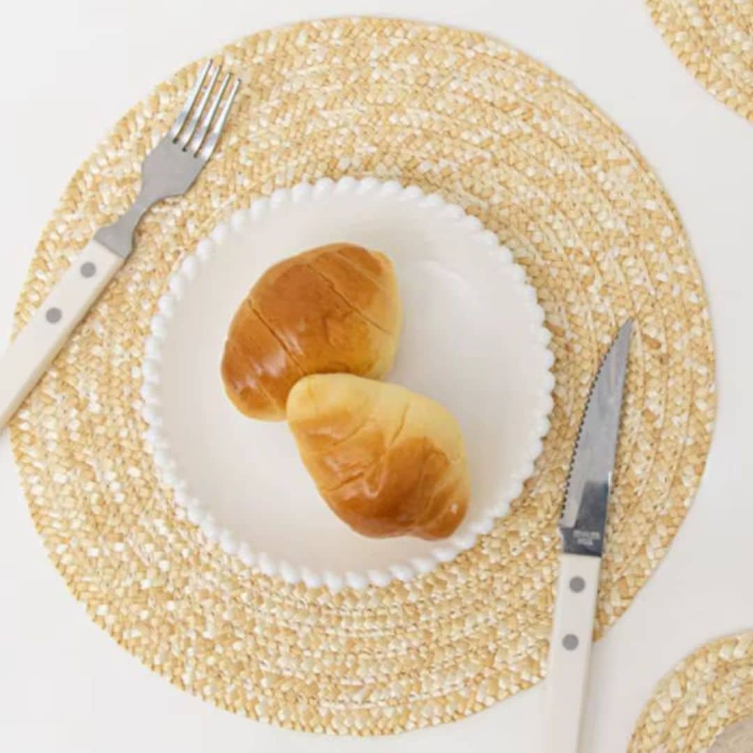 Round sand toned woven linen placemat with a straw look and non slip back