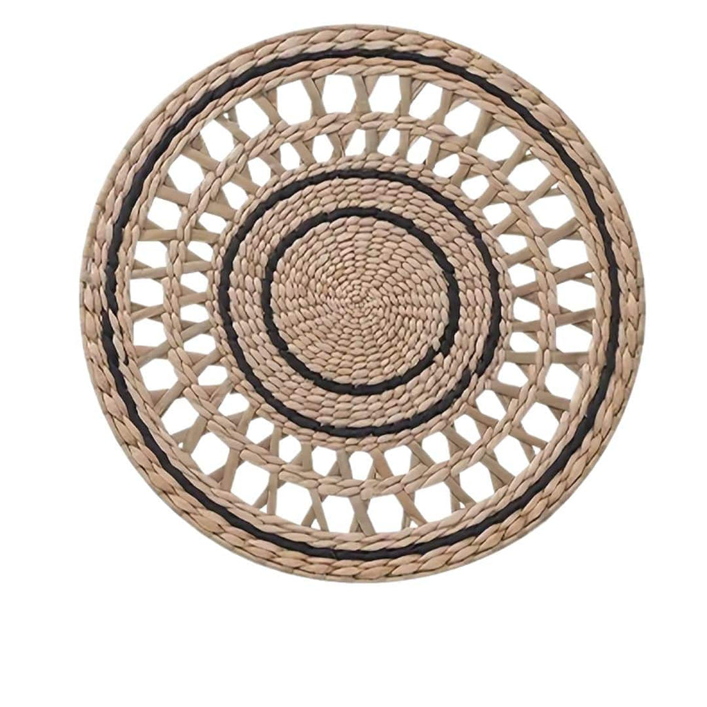 Round openwork woven wall plate with black accents