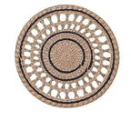 Round openwork woven wall plate with black accents