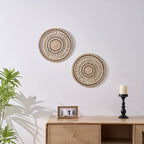 Round openwork woven wall plate with black accents