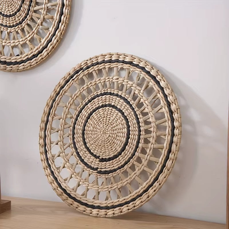 Round openwork woven wall plate with black accents
