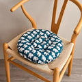 Round chair cushion with white polar bear prints on a deep blue background