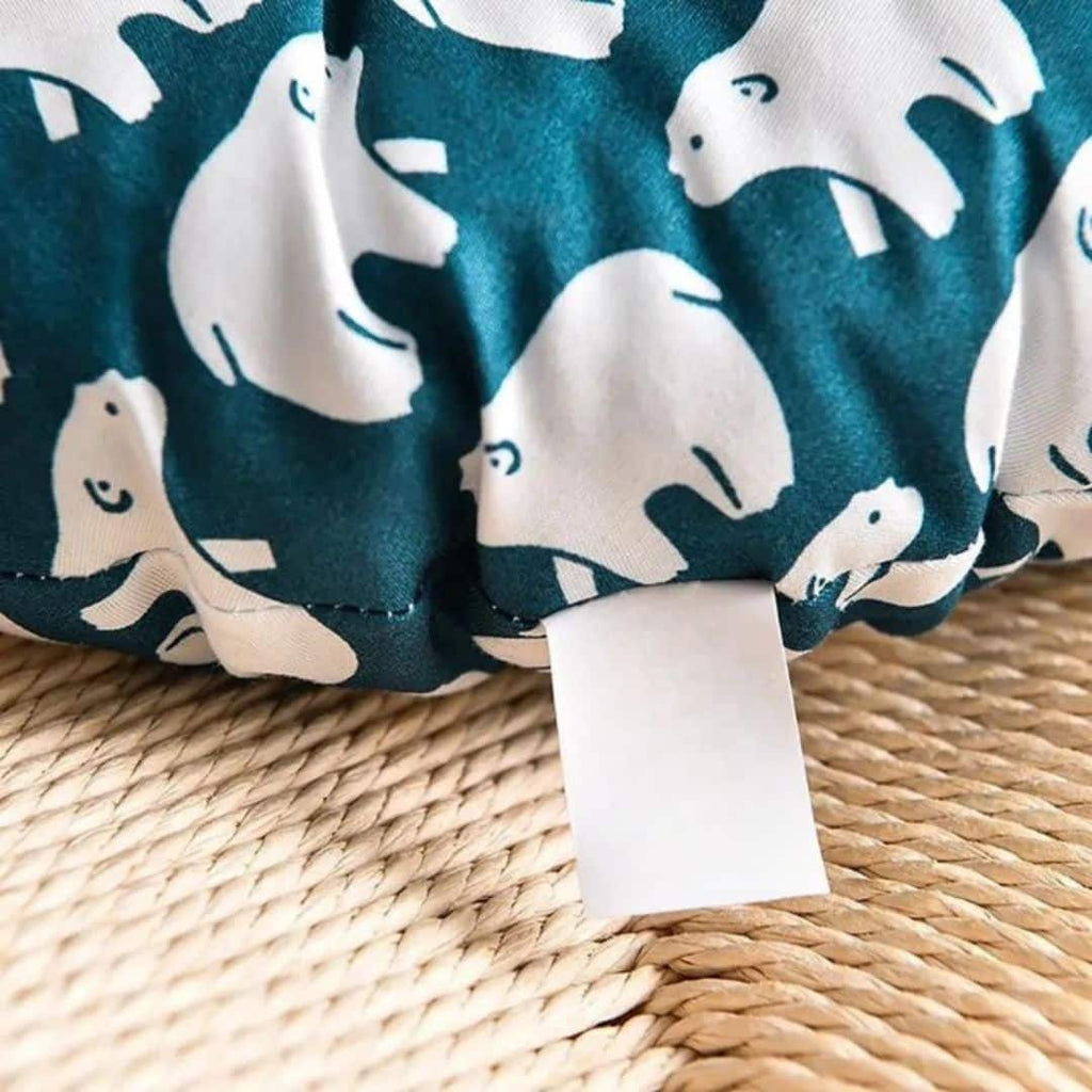 Round chair cushion with white polar bear prints on a deep blue background