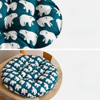 Round chair cushion with white polar bear prints on a deep blue background
