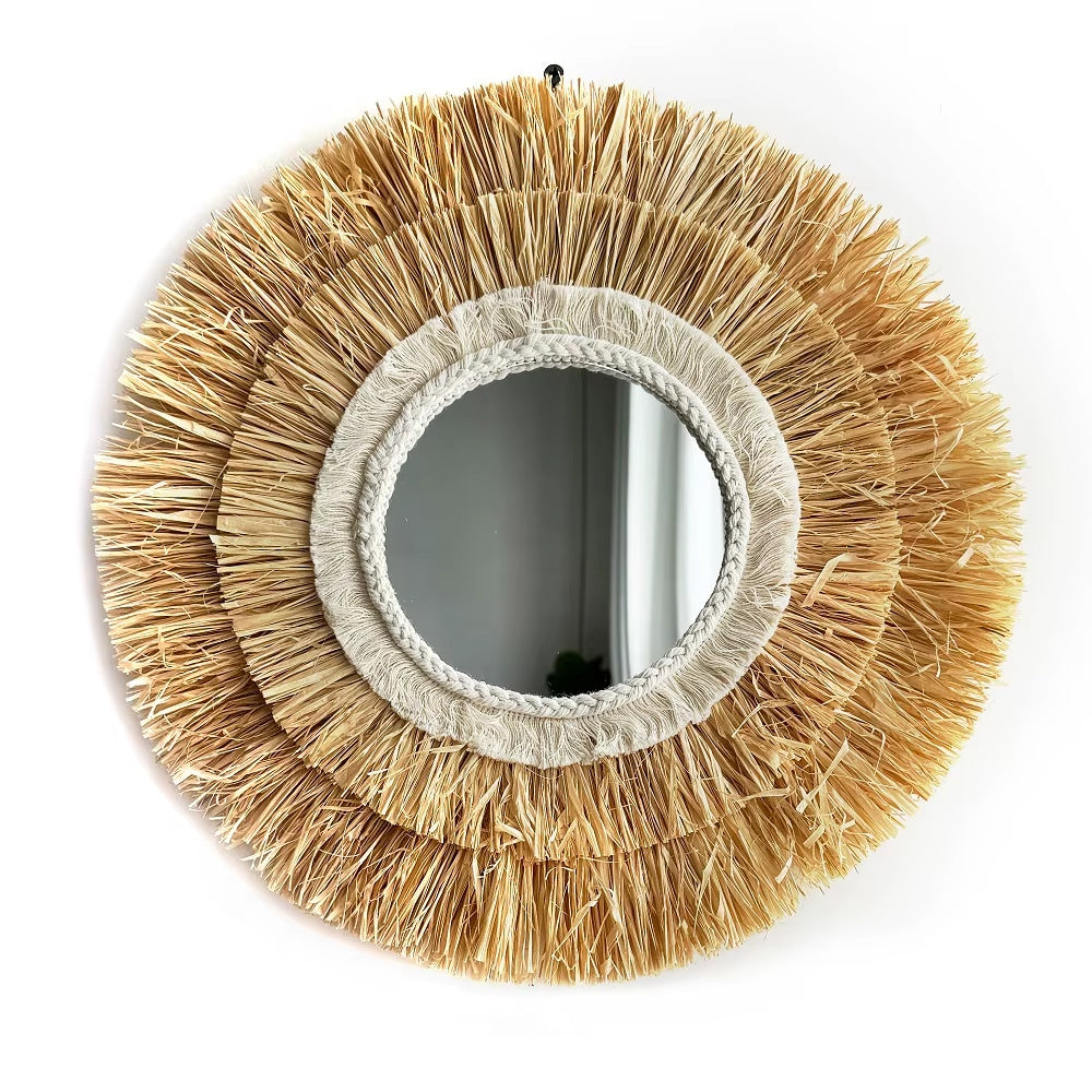 Round mirror framed in layered natural straw fringe