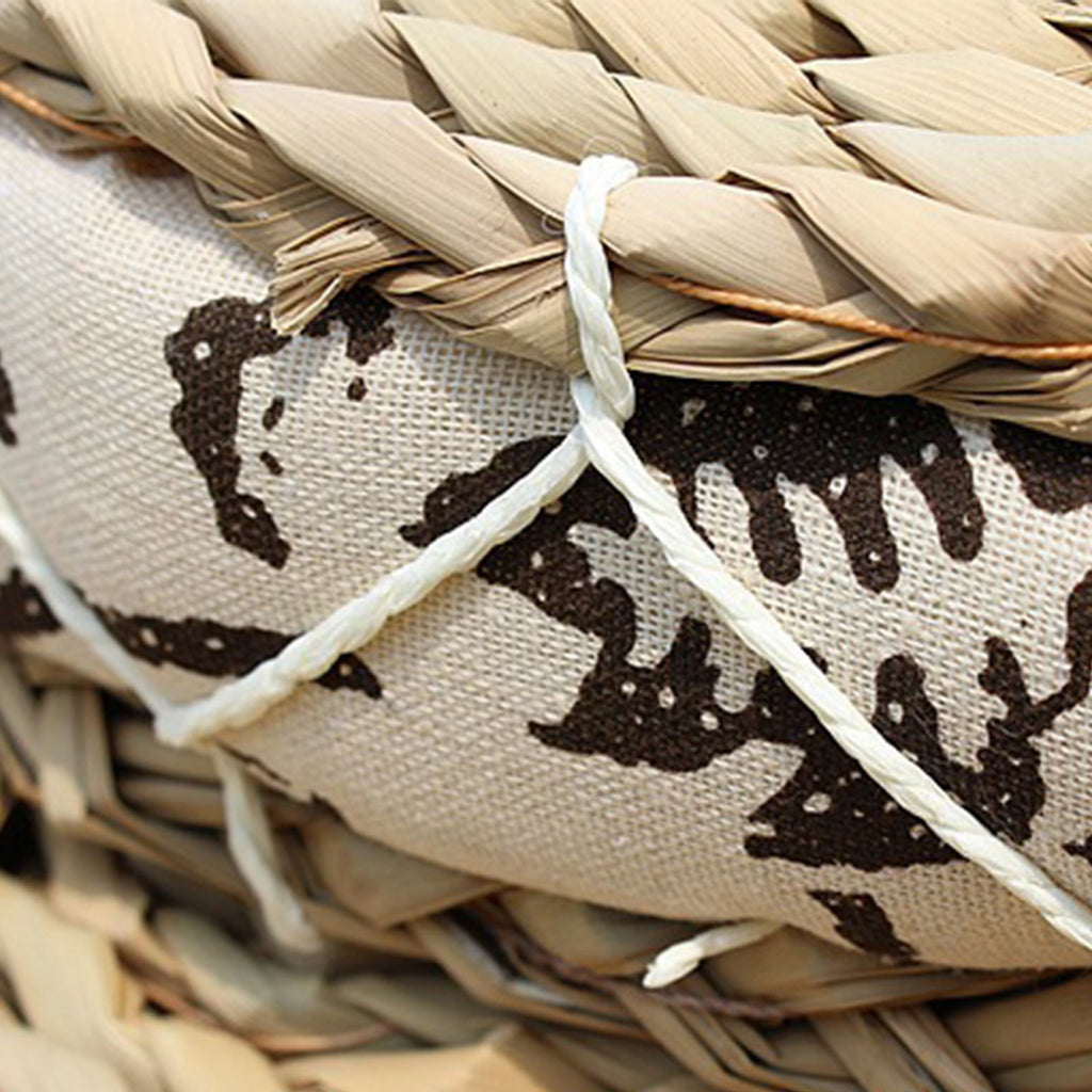 Round hand woven light rattan cushion with a black and white geometric fabric border