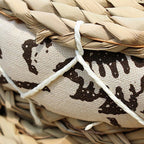 Round hand woven light rattan cushion with a black and white geometric fabric border