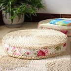 Round hand woven light rattan cushion with a rose fabric border
