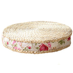 Round hand woven light rattan cushion with a rose fabric border