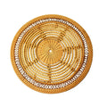 Round beige plastic placemat with a molded woven rattan look