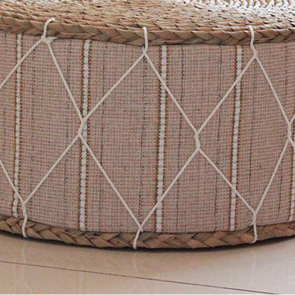 Round hand woven rattan pouf with a beige fabric band