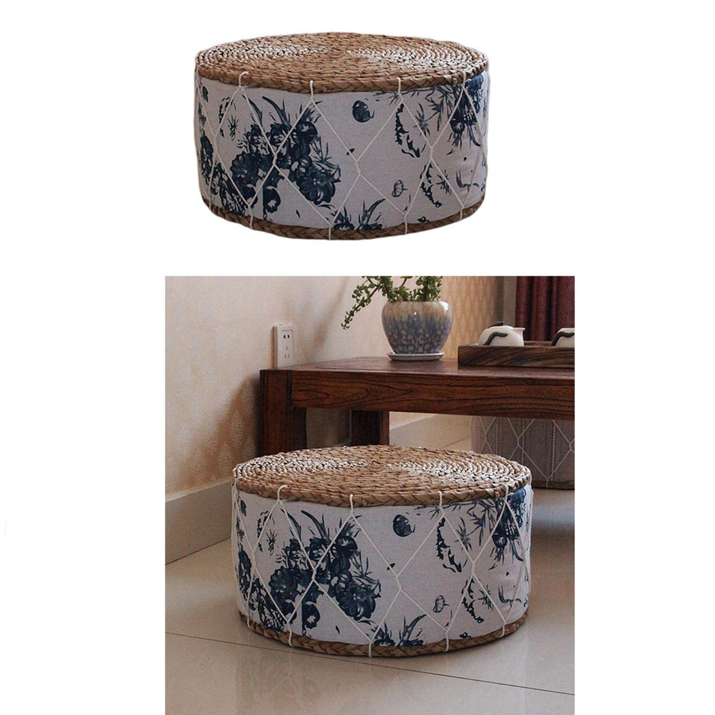 Round rattan pouf with green plant patterns woven on a white ground