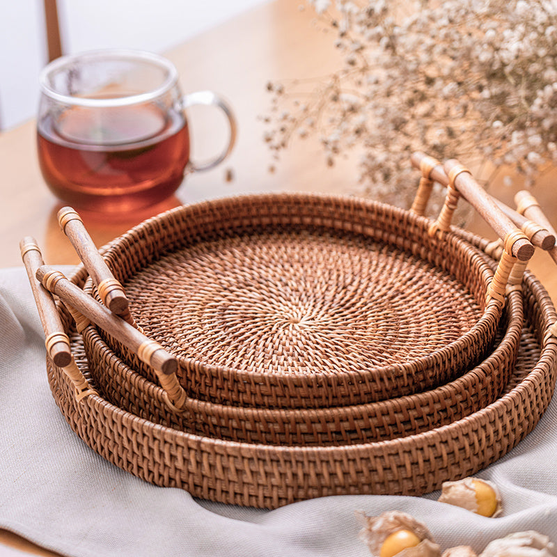 Round rattan serving tray with solid wooden handles