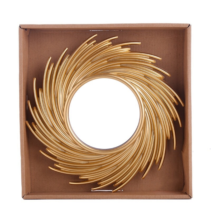 Round mirror framed by swirling rattan rays