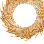Round mirror framed by swirling rattan rays