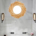 Round mirror framed by swirling rattan rays