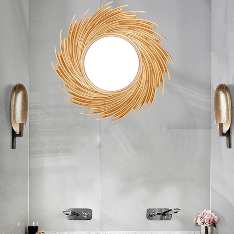Round mirror framed by swirling rattan rays