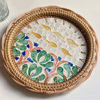Round rattan tray with yellow and green fish motif