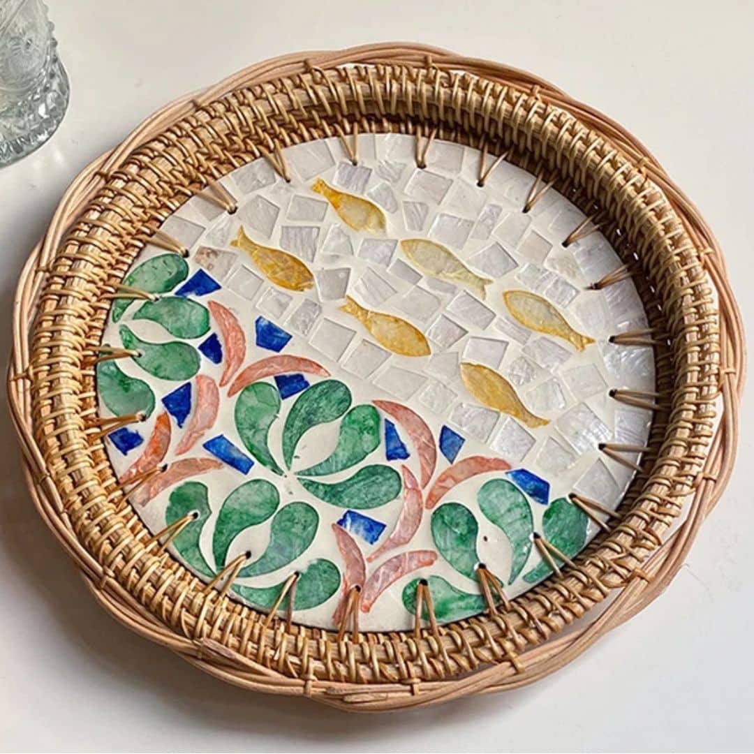 Round rattan tray with yellow and green fish motif