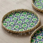 Round woven rattan tray with blue and green geometric pattern