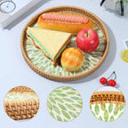 Round rattan tray with green leaf pattern and woven border