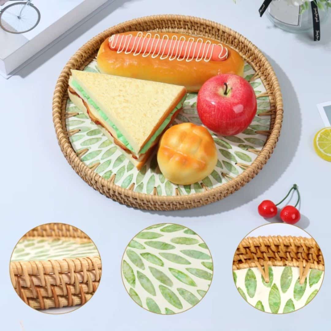 Round rattan tray with green leaf pattern and woven border