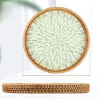 Round rattan tray with green leaf pattern and woven border