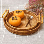 Round rattan serving tray with two light wooden handles
