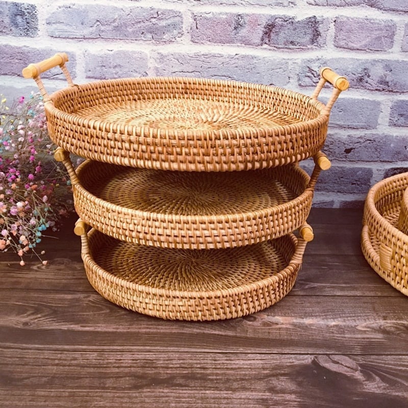 Round rattan serving tray with two light wooden handles