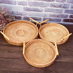 Round rattan serving tray with two light wooden handles