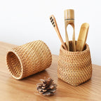 Round honey rattan cups holding wooden utensils