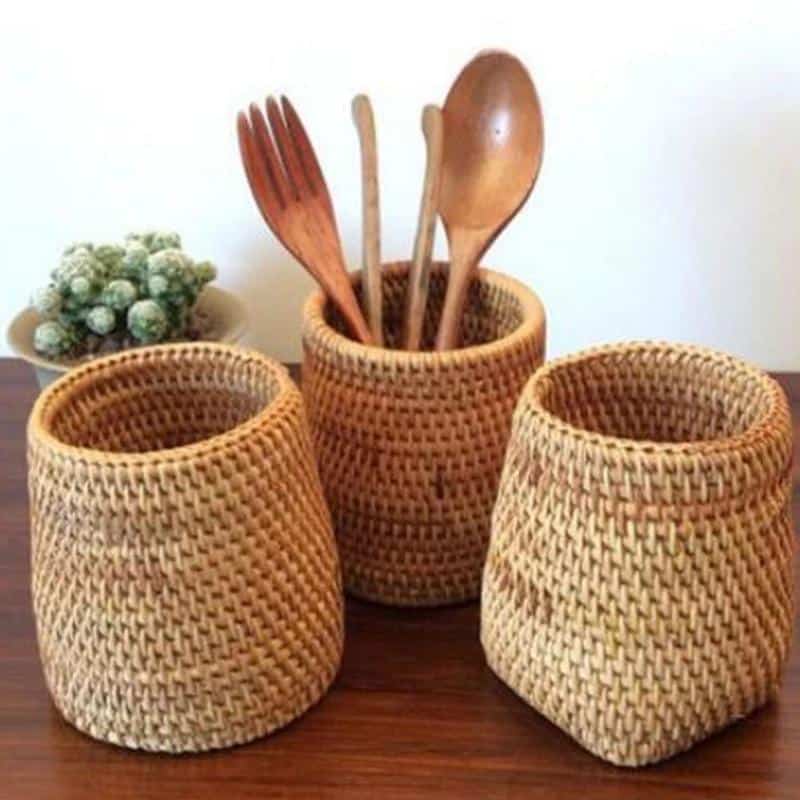Round honey rattan cups holding wooden utensils