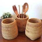 Round honey rattan cups holding wooden utensils