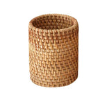 Round honey rattan cups holding wooden utensils