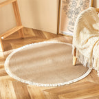 Round two tone braided rug with a cream fringe on a herringbone floor