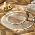 Round two tone braided rug with a cream fringe on a herringbone floor