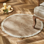 Round two tone braided rug with a cream fringe on a herringbone floor