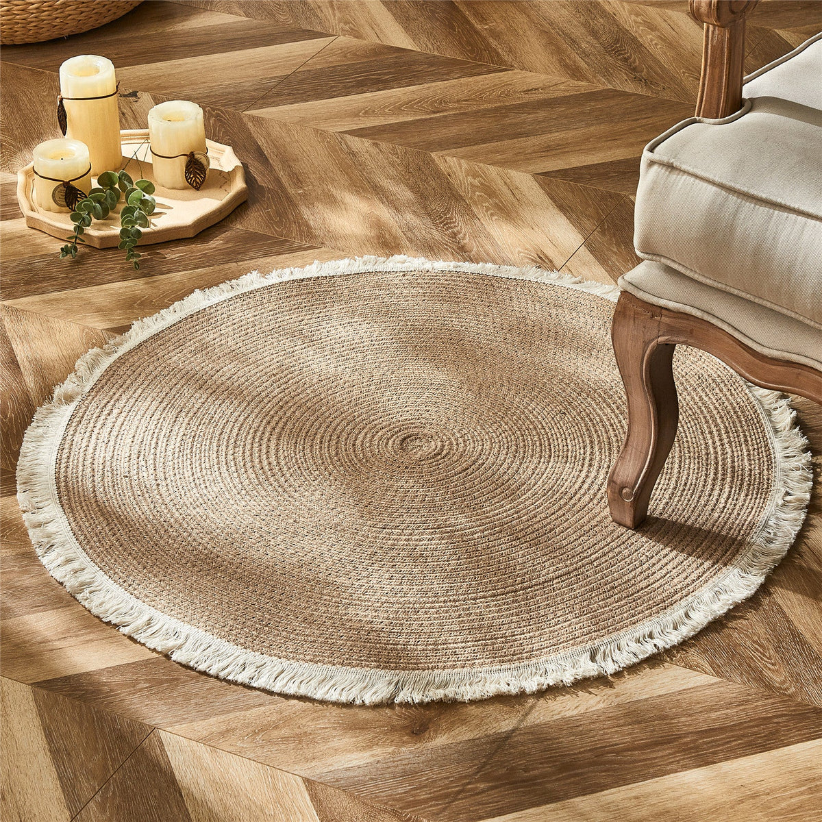 Round two tone braided rug with a cream fringe on a herringbone floor